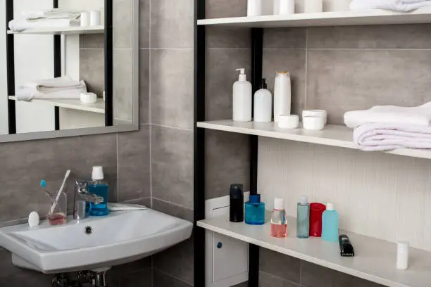 Bathroom cabinets and floating shelves with organized toiletries