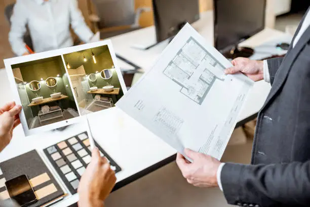 Homeowners reviewing bathroom remodel plans with a contractor