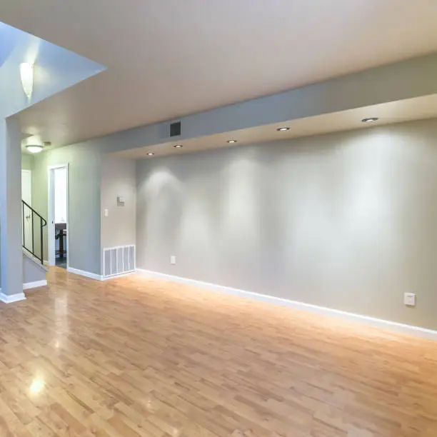 Basement remodeling with layered lighting for a bright and inviting space