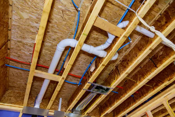 Exposed bathroom plumbing lines during renovation