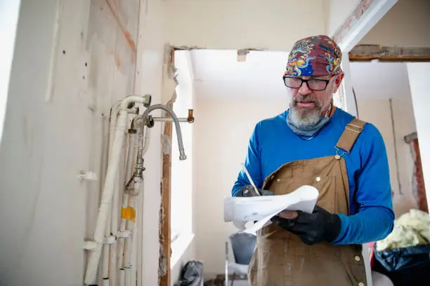 Home inspector evaluating bathroom renovation work