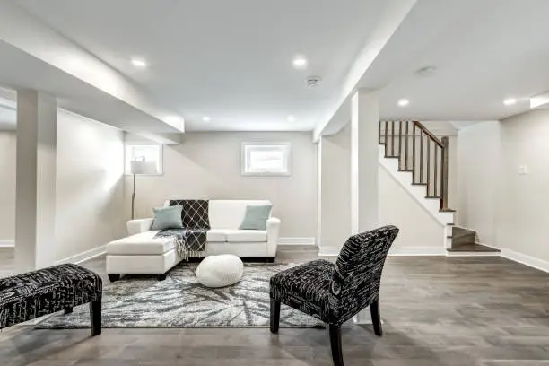 Modern basement design with open-concept layout and stylish furnishings – basement remodeling