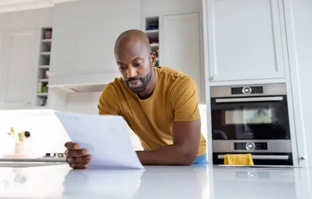 Homeowner reviewing insurance documents and repair estimates