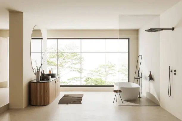 Bright bathroom with large windows and neutral tones