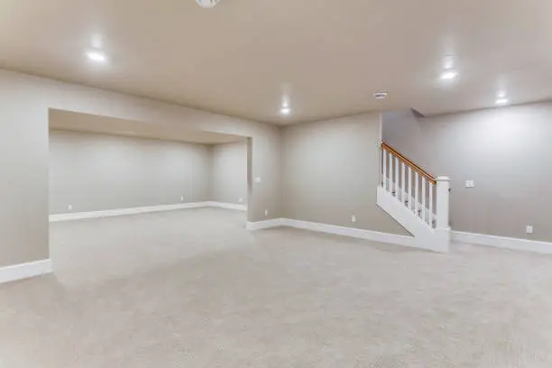Finished basement with hardwood floors and staircase – basement remodeling