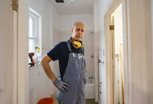 Remodeling contractor working in a small bathroom renovation – bathroom remodel contractors, bathroom renovation