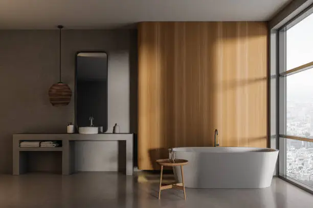 Minimalist spa-style bathroom featuring soft lighting, wood accents, and a soaking tub.
