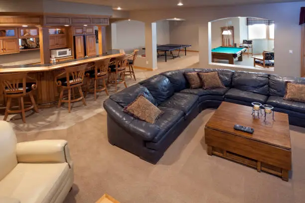 Basement remodeling project with a built-in bar and game area