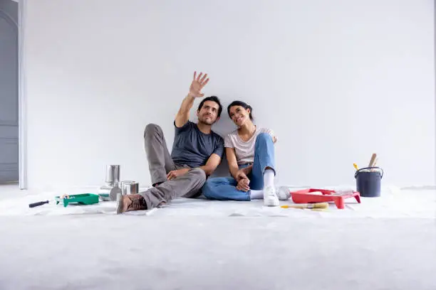 Couple planning home renovation budget with contractor