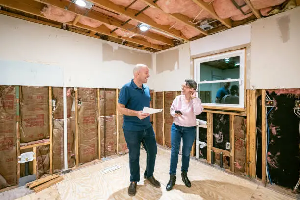 Homeowner consulting with a damage restoration professional