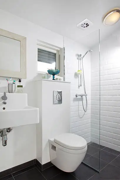 Budget-friendly bathroom renovation with white tiles and minimalist fixtures