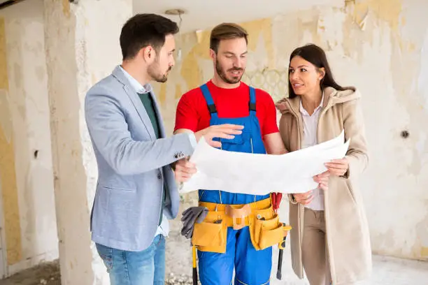  Full home remodeling contractor discussing renovation plans with homeowners