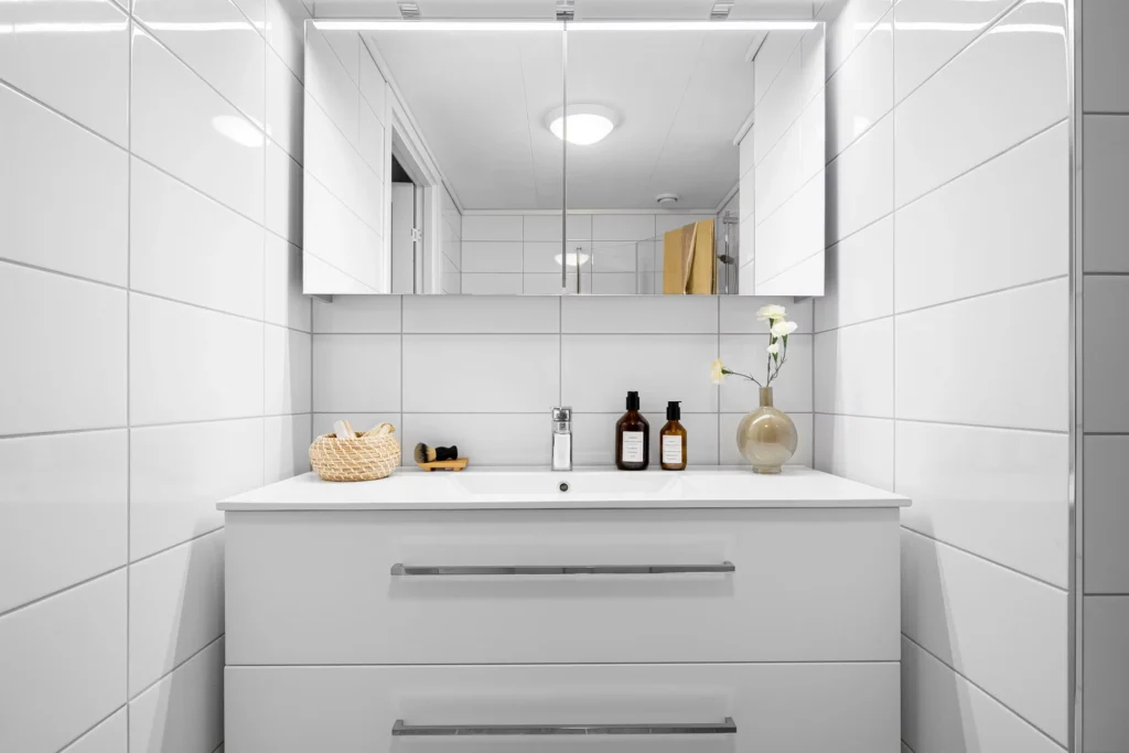 Bathroom upgrade featuring floating vanity with built-in drawers and recessed shelving for smart storage