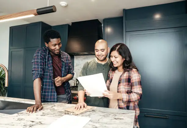 Clients reviewing remodel estimates and schedules for seasonal kitchen and bathroom projects