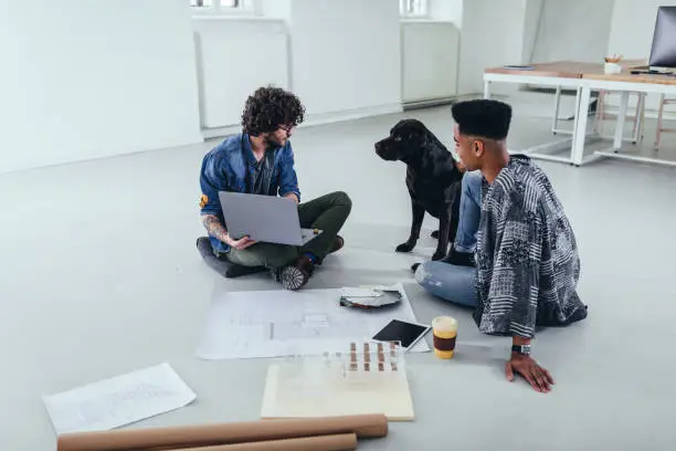 Remodeling contractor discussing pet-friendly home renovation plans with a homeowner