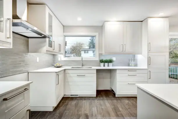 A modern, well-lit kitchen and bathroom remodel combo design featuring accessibility features like grab bars and pull-out shelves.