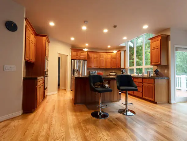 Kitchen remodel combining natural daylight and layered artificial lighting
