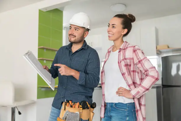 Homeowners reviewing kitchen and bathroom remodel estimates for eco-friendly upgrades