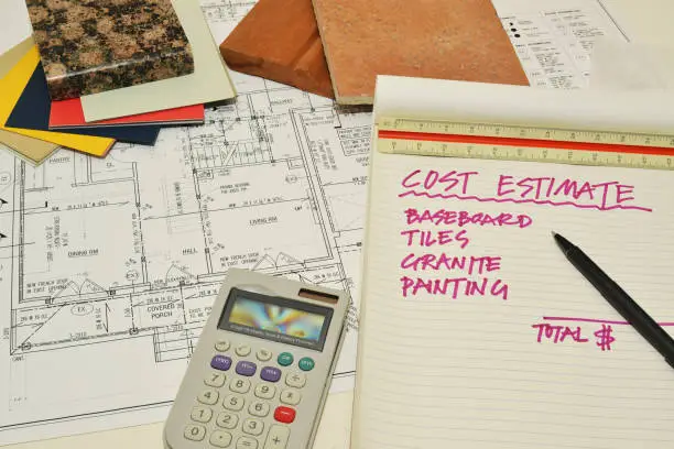 Budget planning for pet-friendly home remodeling with material samples and a calculator on a desk