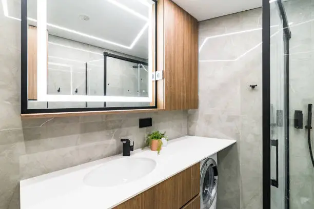 Multi-functional bathrooms with combined laundry, vanity, and guest features in one space.