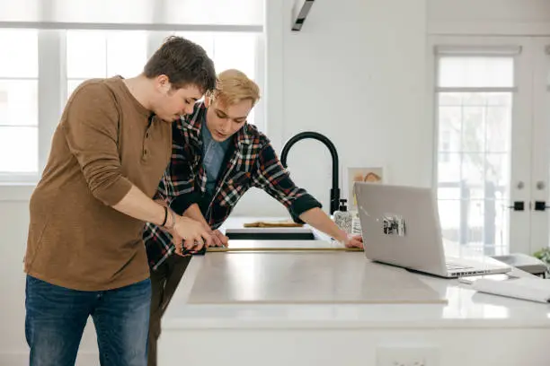Homeowner collaborating with remodel contractor on inclusive kitchen and bathroom design.
