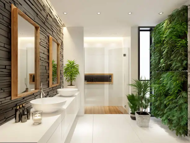 A spa-inspired bathroom with a skylight, indoor plants, and natural stone surfaces, showing how to bring nature into bathroom renovations.