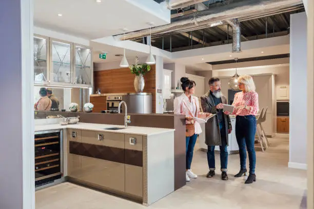 KBR Kitchen & Bath consultant with homeowners inside a showroom.