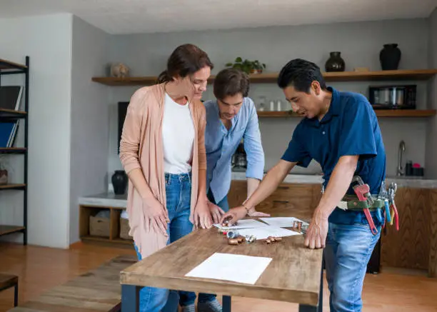 Clients reviewing remodel estimate for resilient kitchen and bathroom improvements