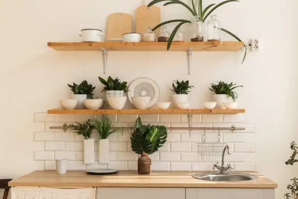 Open shelving in modern kitchen remodels replacing upper cabinets.