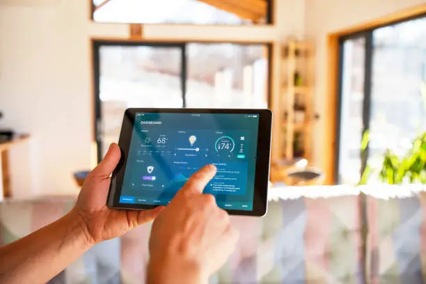 Tablet showing home automation budget next to smart kitchen features