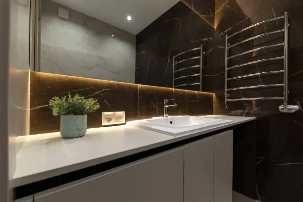 Stylish bathroom with modern finishes, under-cabinet lighting, and practical design.