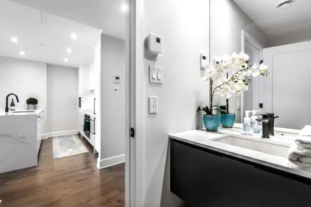 Compact kitchen and bathroom in condo with smart acoustic upgrades
