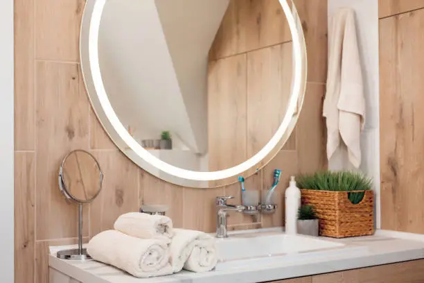 Organized bathroom vanity with soft lighting and storage tailored to morning and evening routines