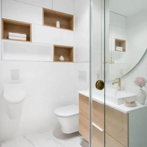 Small bathroom design featuring floating vanity, wall-mounted fixtures, and built-in storage niche.