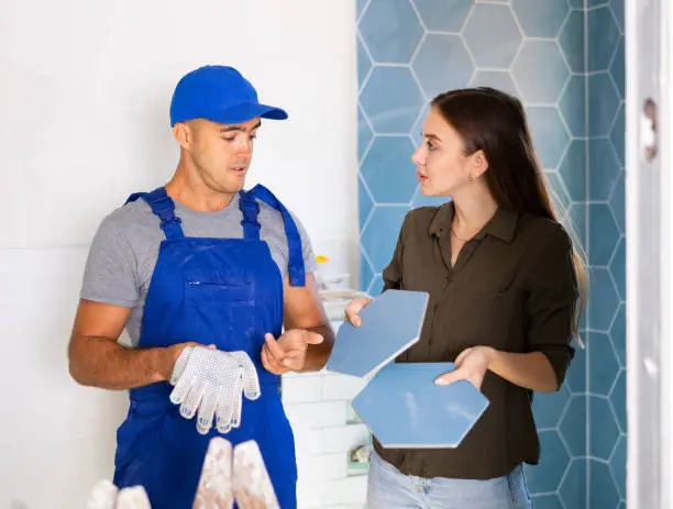 bathroom remodel contractor explaining materials to a homeowner