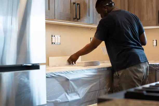 Affordable peel-and-stick backsplash installation in progress during a kitchen remodel.