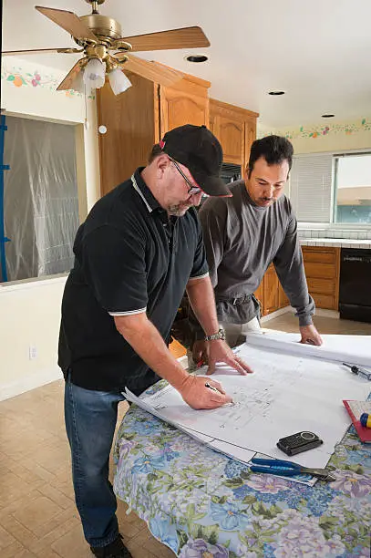 Remodel contractors planning soundproofing layout for kitchen and bathroom upgrade