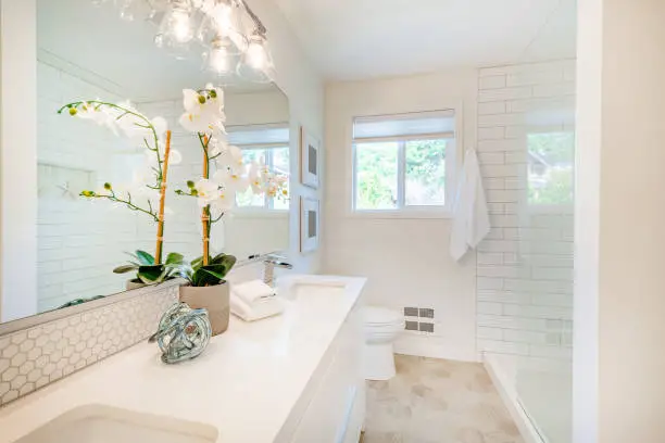 A bright, staged kitchen and bathroom in a modern home ready for sale.