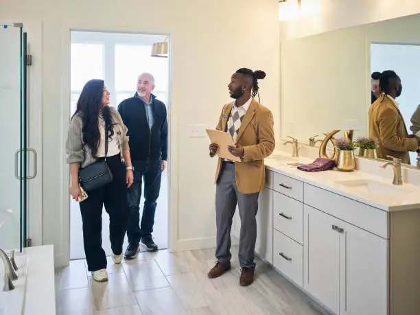 Remodel contractor consulting with homeowners to design kitchen and bathroom for daily habits