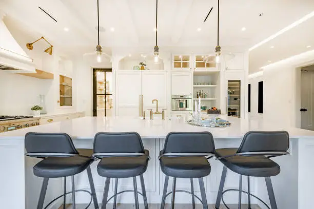 Large kitchen island with stools and beverage center for entertaining