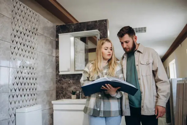 Homeowner reviewing kitchen and bathroom remodel estimates with routine-based features