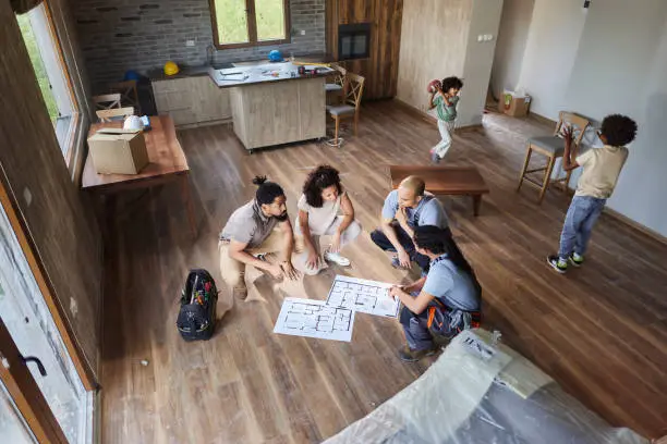 Remodel company installing kitchen flooring with subfloor prep and layout planning