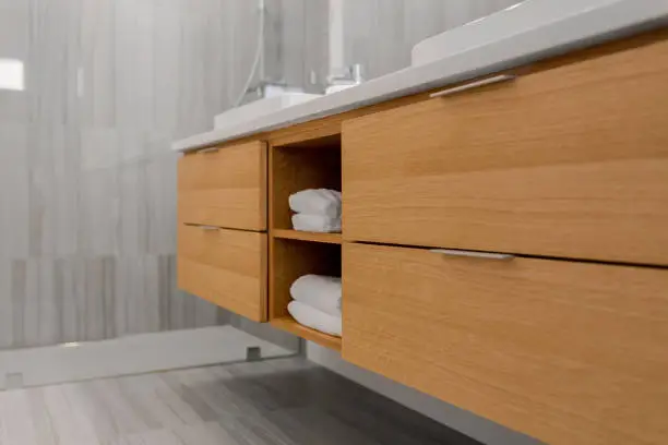 Bathroom remodel featuring under-vanity drawers and hidden shower niche shelving