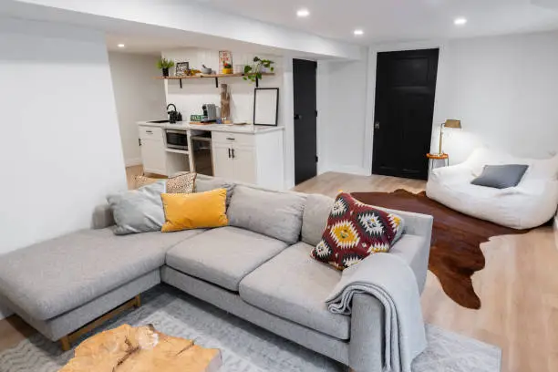 Modern basement remodel transformed into a home wellness retreat with calming lights and functional zones.
