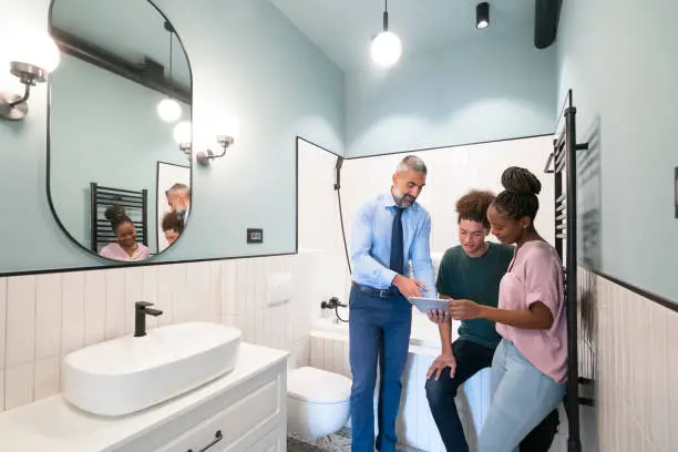 bathroom remodelers planning renovation with homeowners