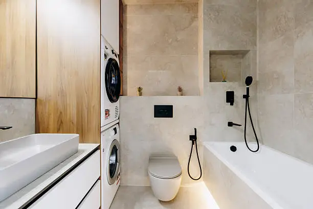 A modern, compact bathroom showcasing smart storage, a washer-dryer combo, and clean aesthetics.