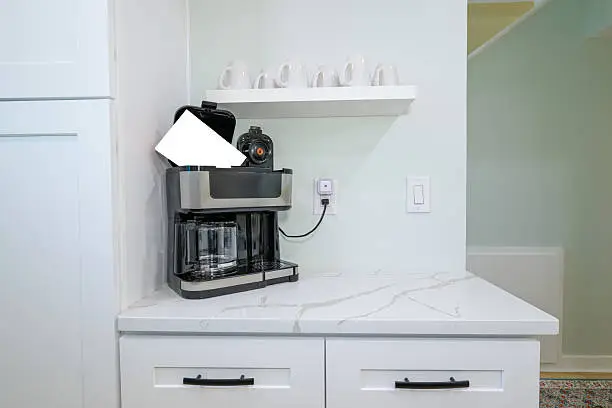 Custom coffee station and recharge zone in a kitchen remodel supporting remote work routines