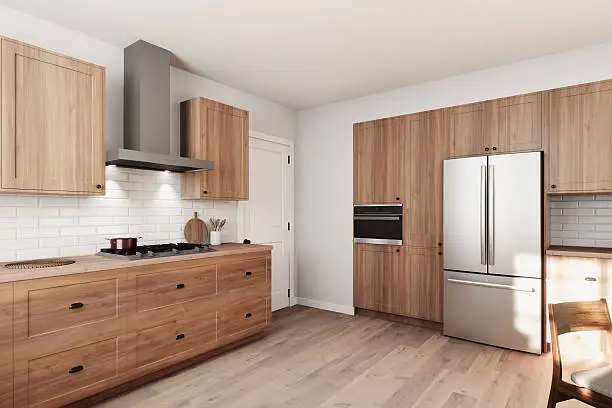 Modern, neutral kitchen with open layout and stainless appliances.