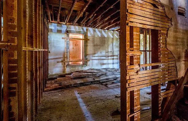 Exposed wood beams and foundation repair in historic home remodeling