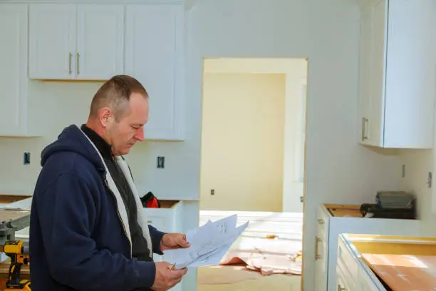 Contractor reviewing kitchen and bathroom remodeling plans for a historic home